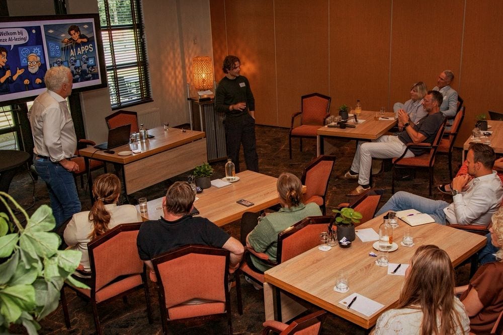 Two speakers opening an AI talk for a group of participants seated at tables